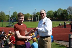 Cadet D. Maddison collecting his gold medal from Wing Commander Andy Griffin Officer Commanding West Mercian Wing for coming 1st in 400m in his age category during the athletics event.