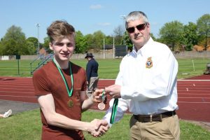 Cadet D. Maddison collecting his second medal(!) from Wing Commander Andy Griffin Officer Commanding West Mercian Wing for coming 2nd in 200m for his age category during the athletics event.