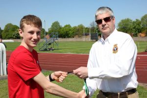 Cadet S. Jones collecting his gold medal from Wing Commander Andy Griffin Officer Commanding West Mercian Wing for coming 1st in 1500m for his age category during the athletics event.