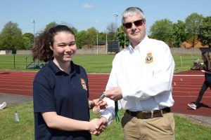 Cadet Flight Sergeant C. Weetman collecting her bronze medal from Wing Commander Andy Griffin Officer Commanding West Mercian Wing for coming 3rd in 200m for her age category during the athletics event.