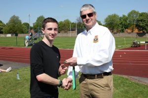Cadet Flight Sergeant A. Killeen collecting his bronze medal from Wing Commander Andy Griffin Officer Commanding West Mercian Wing for coming 3rd in 200m for his age category during the athletics event.